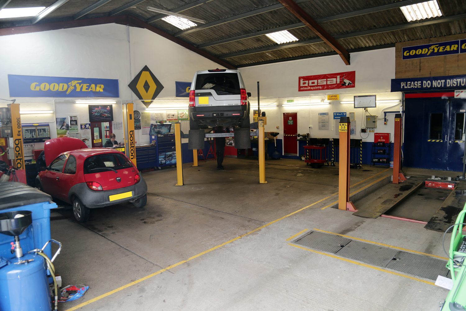 Inside the Devoran Autocare workshop with vehicles on ramps